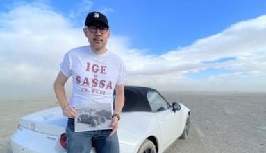 Oliver Wang leaning on car in desert